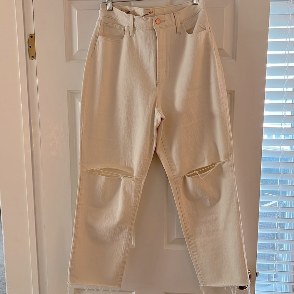 Cream Universal Threads jeans with raw hem and rips in the knees!
